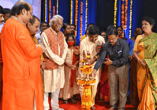 Parishath members lighting the ceremonial lamp at an event