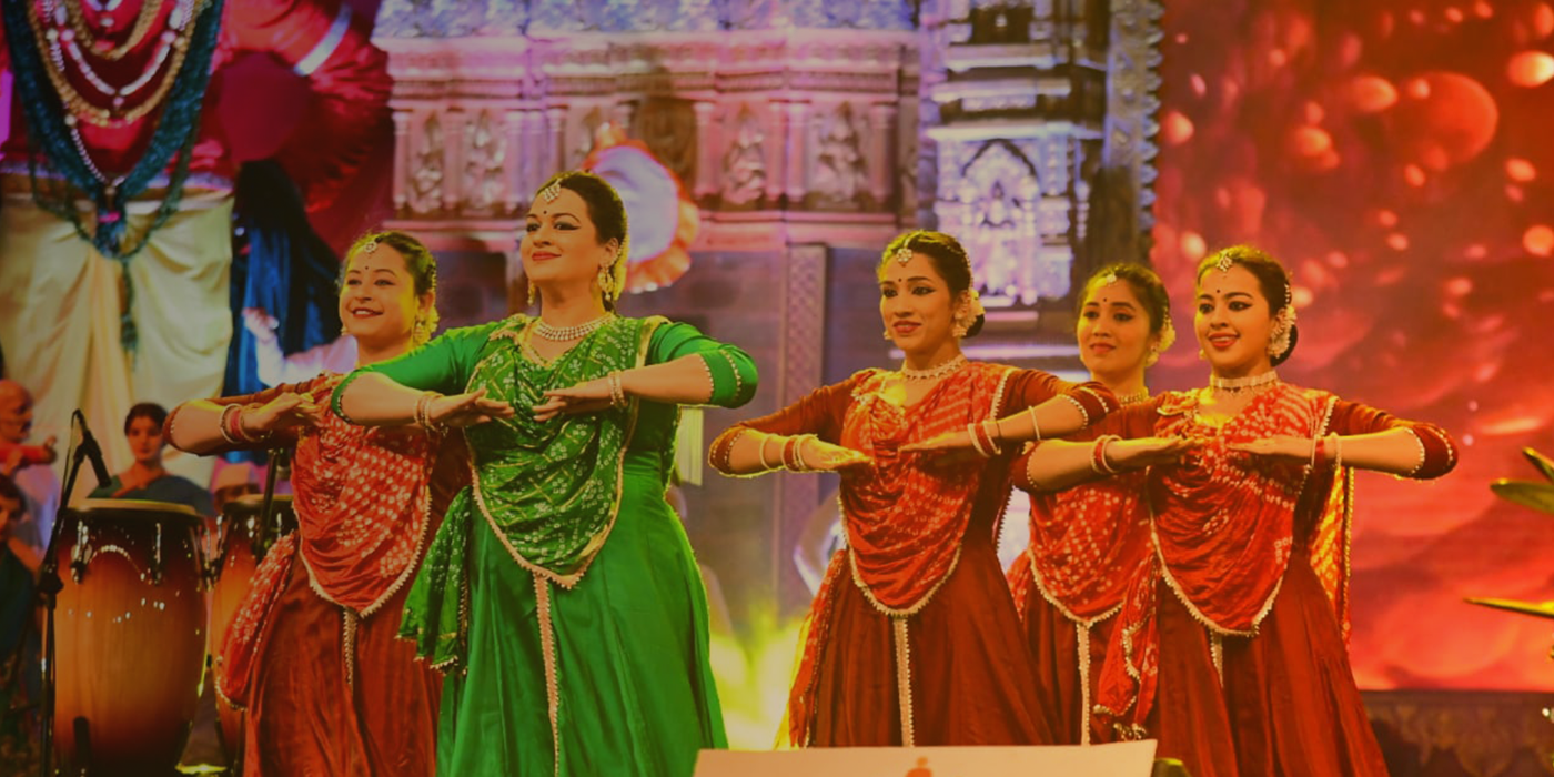 Indian dancers performing on a decorated stage